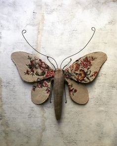 a butterfly made out of fabric and wire