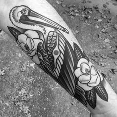 a black and white photo of a pelican with flowers on it's arm