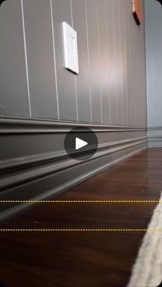 an image of a room with wood flooring and white rugs on the floor