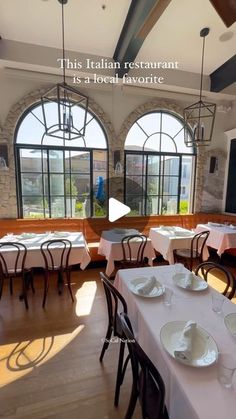 an image of a restaurant setting with white tablecloths and plates on the tables