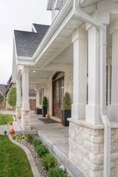 the front porch of a house with white columns