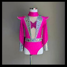 a pink suit with silver sequins on the chest and back, sitting on a mannequin