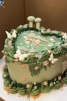 Green fairy woodland cake with flowers and mushrooms