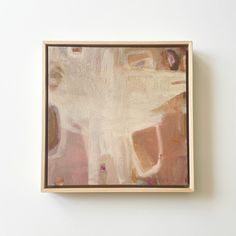 an abstract painting is hanging on the wall