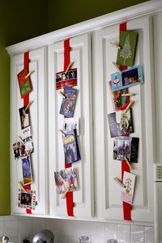 the kitchen cabinets are decorated with pictures and magnets for holiday cards to hang on