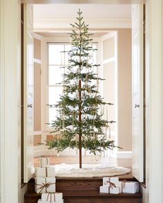 a small christmas tree in the corner of a room