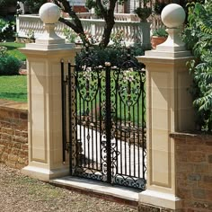 an iron gate with two white balls on top