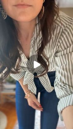 Julia Alexandra on Instagram: "The much requested bow hack for your button up tops. How you get that perfect knot that lays flat is actually...not to make a knot at all. 

Tuck the shirt tails through the bottom two buttons and pull through! It lays flat and you can adjust the waist as you please! 

For the links to the shirt / jeans / shapewear comment "hack" below!" How To Tie A Top Knot, Jeans With Long Top, How To Tie A Bottom Up Shirt, Jeans Button Down Shirt Outfit, How To Tie A Flannel Shirt Knot, Tied Button Up Shirt Outfit, How To Button A Shirt Hack, How To Tie Shirt Around Waist, Clothe Hack