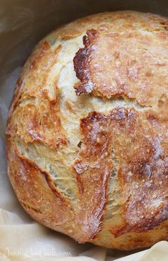 a loaf of bread sitting on top of a piece of wax paper in a bag