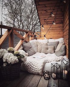 an instagram photo with a couch and some flowers on the porch next to it