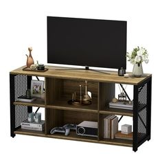 an entertainment center with shelves and a flat screen tv mounted on it's side