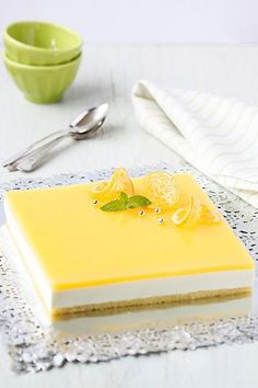 a piece of cake sitting on top of a table next to a bowl and spoon