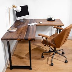 an office desk with a computer on it and a chair in front of the desk