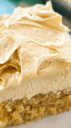 a close up of a piece of cake on a plate with peanut butter frosting