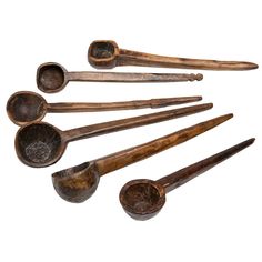 an assortment of old wooden spoons and ladles