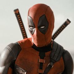 a deadpool character with two swords in his hands