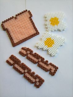 four pieces of bead art on a white surface