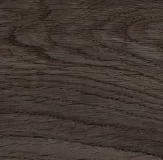 a close up view of wood grain textured with dark brown stain on the surface