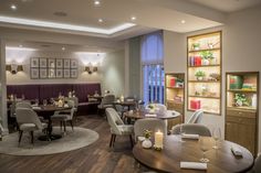 a restaurant with wooden tables and white chairs