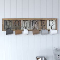 a wooden sign that says coffee hanging on the wall