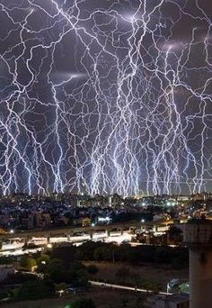 an image of lightning in the sky over a city