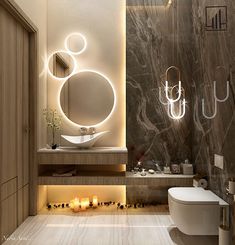 a modern bathroom with marble walls and flooring, lighted by lights above the toilet