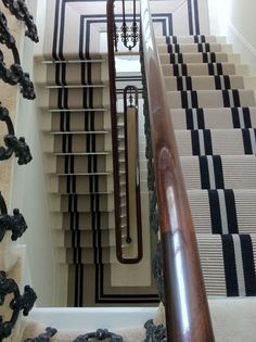 the stairs are lined with black and white carpet