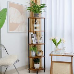 a corner shelf with plants and books on it next to a chair in front of a window