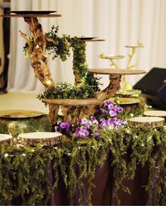 the table is decorated with moss and candles