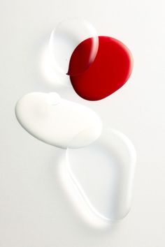 two red and one white objects on a white surface, with the same object above them