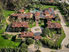 an aerial view of a large estate surrounded by palm trees