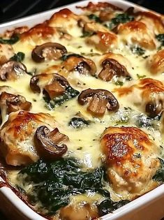 a casserole dish with mushrooms, spinach and cheese