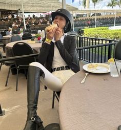 a woman sitting at a table eating food