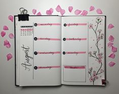 an open planner with pink flowers on it