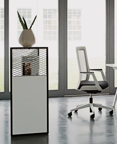 an office chair next to a desk with a magazine rack