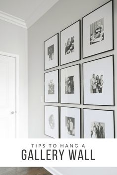 black and white photographs are hung on the wall above a wooden floor in this living room