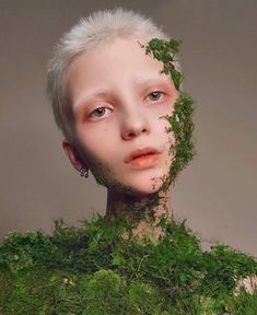 a woman with white hair and moss on her face