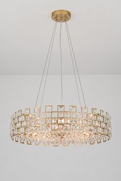 a chandelier hanging from the ceiling in a room with white walls and flooring