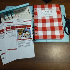 a recipe book and scissors on a table