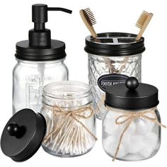 mason jars with toothbrushes, soap dispenser and brush in them