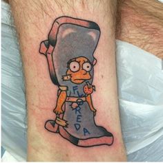 a cartoon character tattoo on the arm and leg, with an image of a man holding a