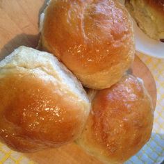 three rolls sitting on top of a white plate