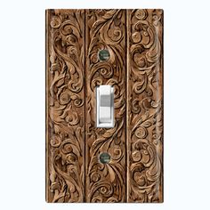 an ornate wooden light switch cover