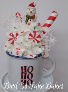 a cup filled with whipped cream and candy canes