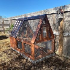 a chicken coop in the middle of a yard