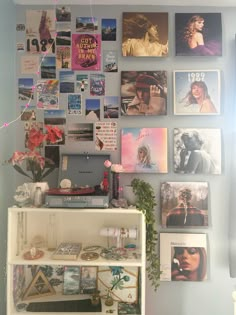 the wall is covered with pictures and posters