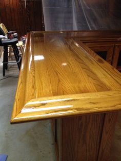 a large wooden table sitting inside of a room next to a chair and other furniture