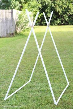 a white metal stand in the grass