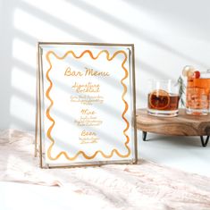 a table with two glasses and a menu on it