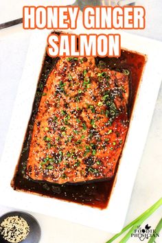 honey ginger salmon in a white dish with sesame seeds on top and the title overlay reads honey ginger salmon salmon